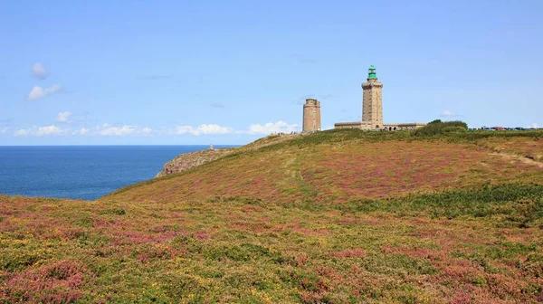Old lighthouse and flowers at Cap Frehel, Brittany. English Channel. French Coast.
