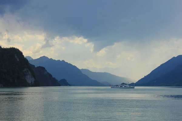 Boat on Lake Brienz and moody sky.