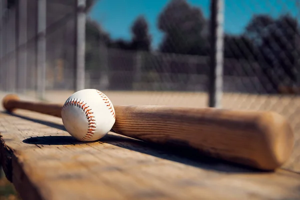 Baseball and baseball bat on wooden table background