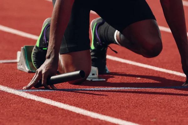 Runner crossing finishing line on track stock photo