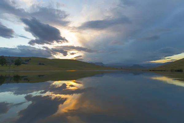 Puesta de sol y reflejo de nubes en el agua — Foto de Stock