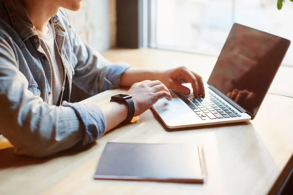 Jonge man werkt op de laptop in het café. — Stockfoto