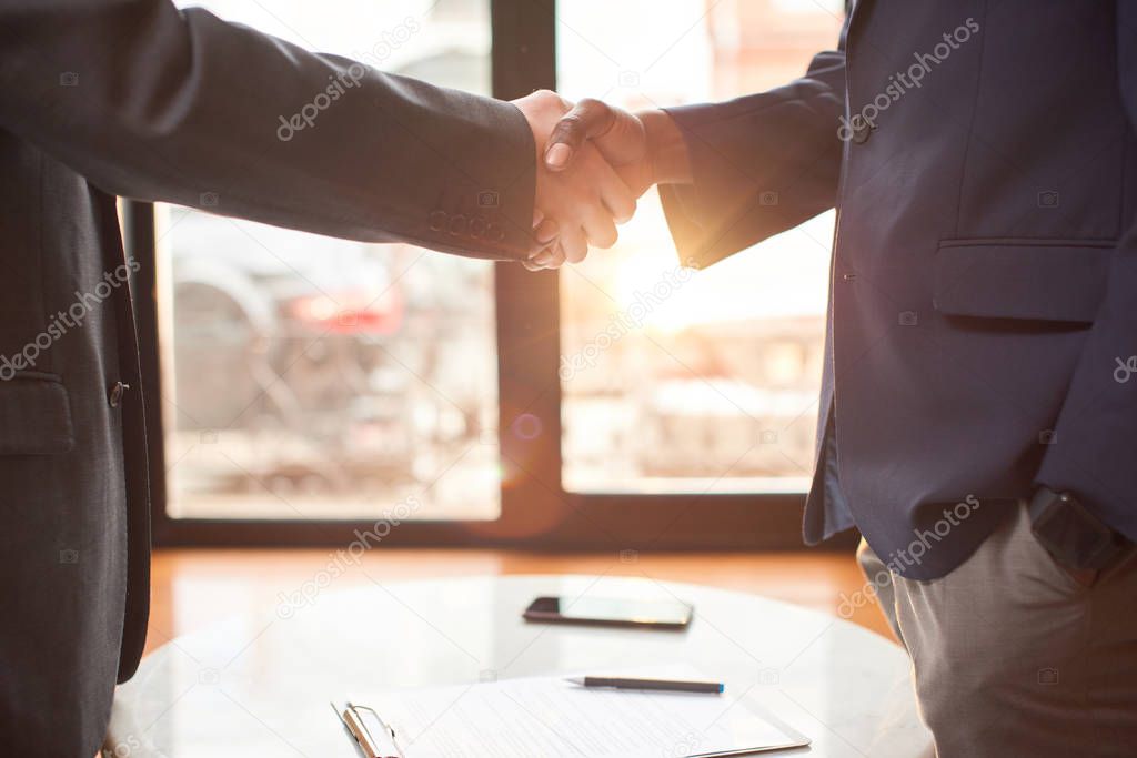 Close up. Two businessmen shaking hands after a successful contract.