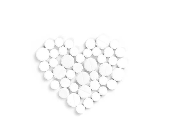 Pillole di medicina bianca a forma di cuore su uno sfondo bianco vista dall'alto con spazio di copia . — Foto Stock