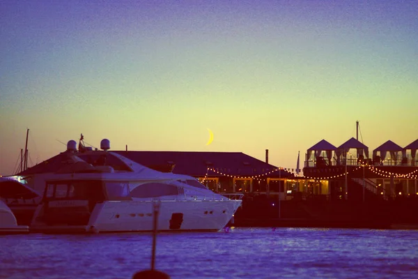 view of the piers of the yacht and the moon. nightlife and restaurants on the water