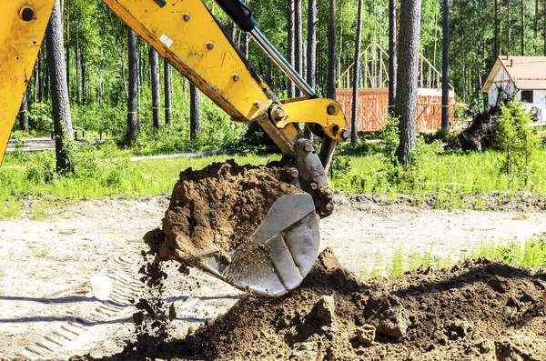 the work of a large two-wheeled tractor when laying water supply for water supply of private homes. the concept of building a country house.