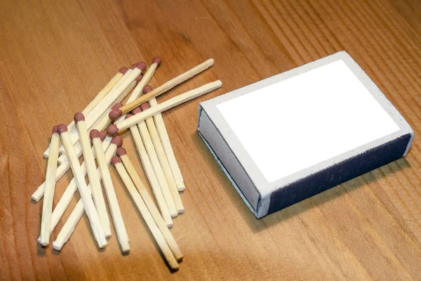 boxes of matches on a wooden background, makeup blank, matches for advertising on the UPS Billboard.