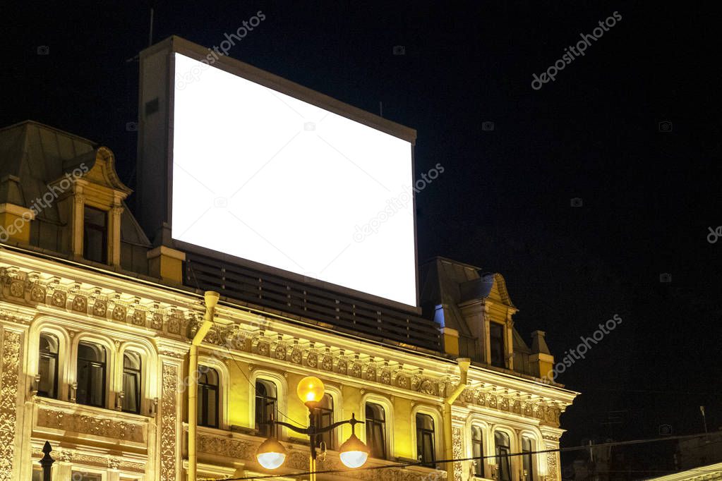 huge Billboard on the building in the night city, night advertising, ready layout for outdoor advertising.