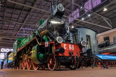 Russia, St. Petersburg, February - 2020: Russian Railways Museum of Russia, a large classic passenger steam locomotive released in 1917. the serial name of the passenger steam locomotive C68. clipart
