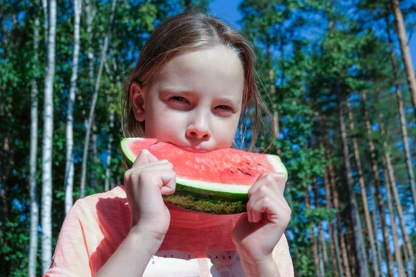 summer concept. Happy young girl eating watermelon on a sunny day. Youth lifestyle. food, relaxation, tasty, happiness, joy, beach.