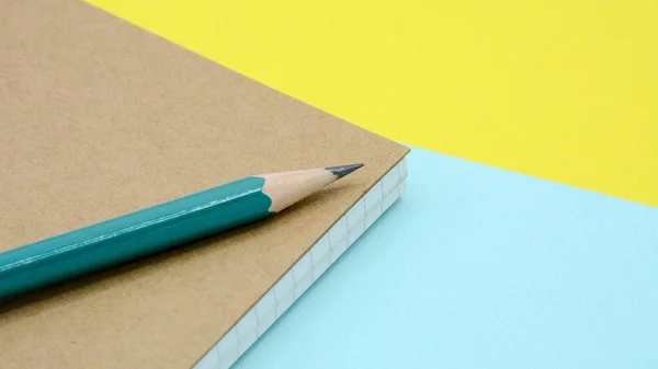 green pencil on a diary book