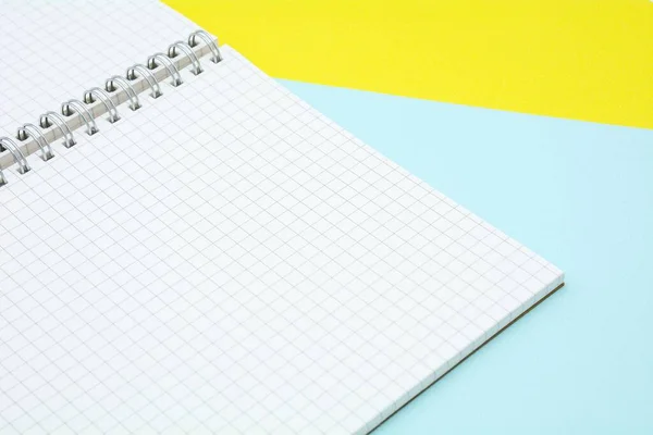 white grid paper book on blue and yellow background