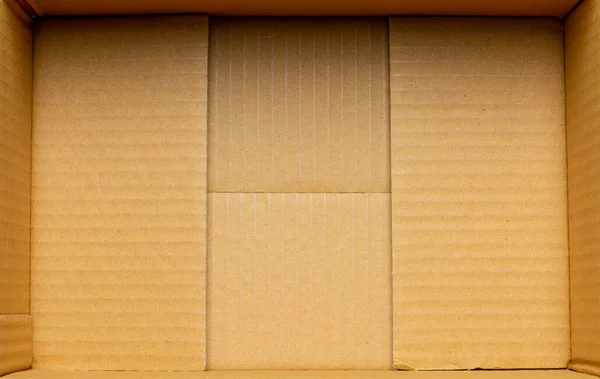 Inside a empty cardboard packaging box.