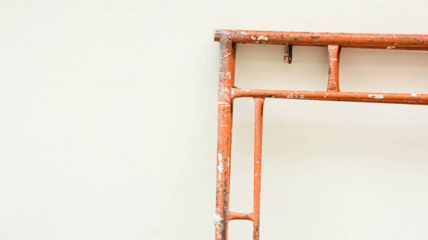 orange scaffolding at the wall