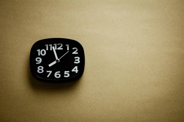 Schwarze Uhr Auf Braunem Recyclingpapier Hintergrund — Stockfoto