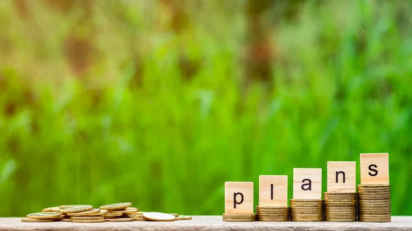 Plans Word Stack Coins Pile Golden Coins Wooden Table — Stock Photo, Image