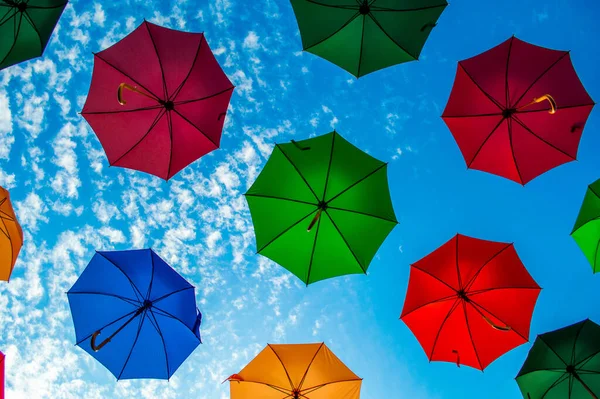 Multi colored umbrellas with blue sky. Background Colorful Umbrella Street Decoration.