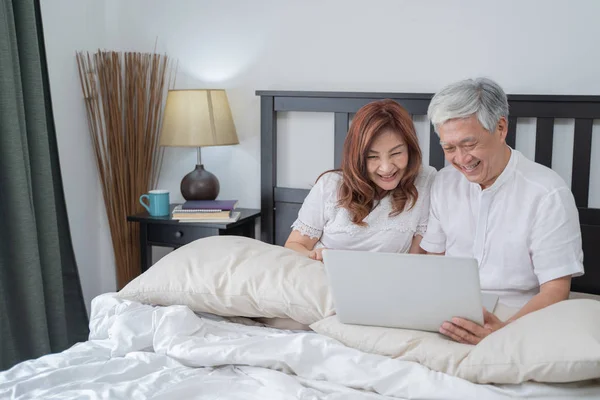 Happy Asian Senior Couple  lifestyle technology device concept,Lovely elderly couple using laptop computer