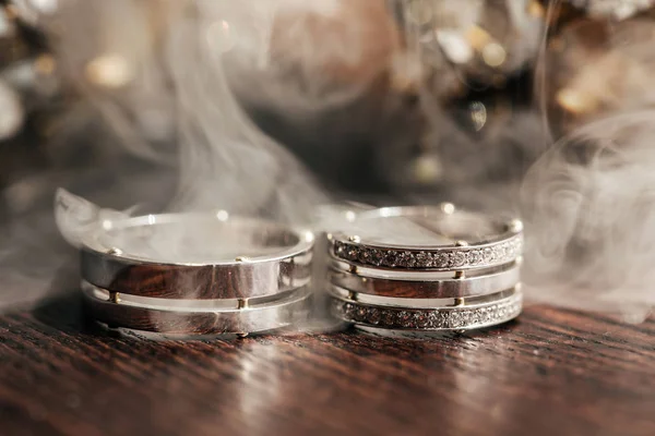 wedding white rings on the table with smoke