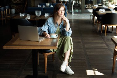 Genç kız kahve içme ve telefonda konuşmak