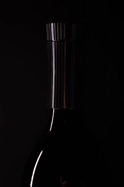 Empty bottle on black background. Bottle silhouette — Stock Photo, Image