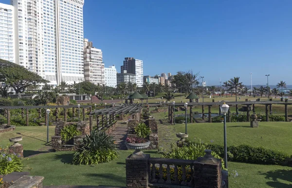Sunked gardens against Golden Mile beachfront city skyline and blue sky in Durban, South Africa