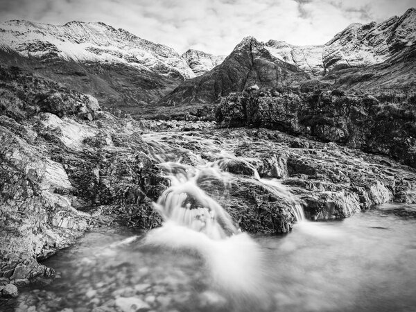 Legendary Fairy Pools at Glenbrittle at the foot of the Black Cuillin Mountains. Small waterfall with colorful pools,  Isle of Skye, Scotland