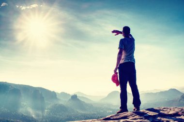 Fiyatı gözleri gölgeleme ve puslu sabah peyzaj üzerinde izlerken kaya tepe üzerinde. Doğada yürüyüş