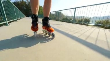 Satır içi roller skater bacaklarını kapat. Göl köprü yolda sert kabuğu yüksek teknoloji paten buz pateni. 