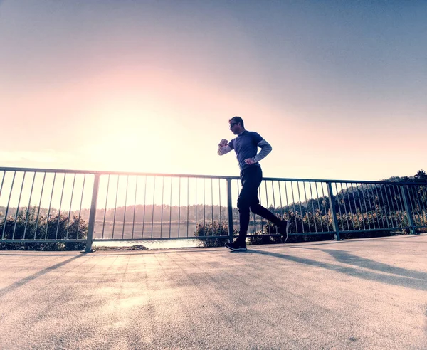 Alto Hombre Delgado Correr Terraza Del Lago Contra Telón Fondo — Foto de Stock