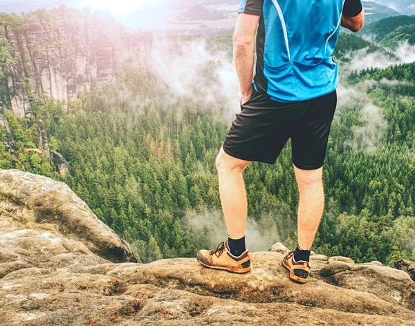 Walking comfortable shoes. All terrain shoes. Hiking  boots on hiker outdoors walking crossing rocky traail. Fall hike in pure nature