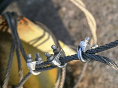 Shackles attached to wire cables and safety net.  Stainless steel screw bolt and wires for maintaining tightened safety net clipart