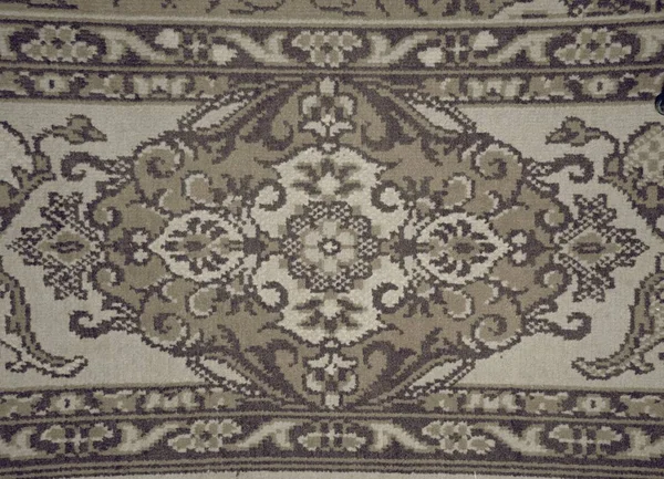 Old worn carpet in detail. Weaving texture or weaving pattern background.
