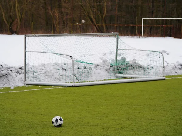 Soccer play field grass in winter. Artificial green turf texture