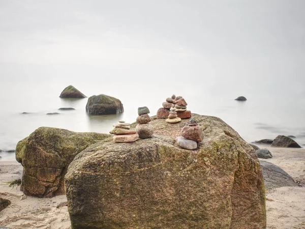 Zen stones pyramids in the beach