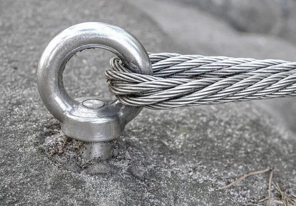 Stainless cable fixed to the rock for the safety — Stock Photo, Image