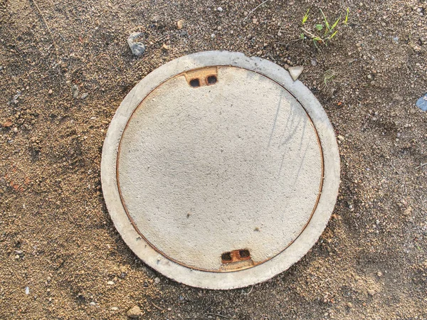 Manhole with the concrete cover on basement — Stock Photo, Image