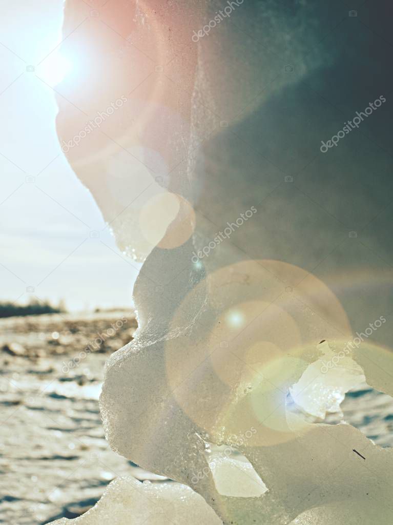 Piece of ice with contour and sun flares