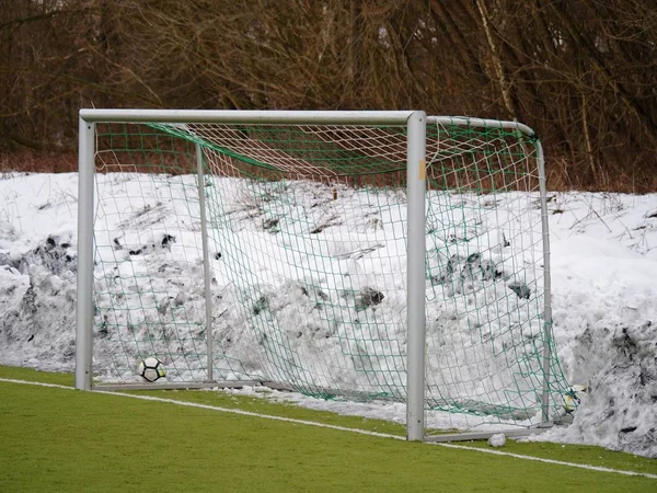 Soccer play field grass in winter. Artificial green turf texture