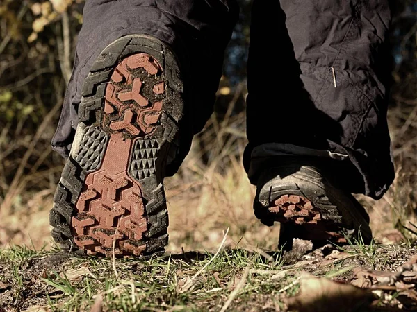 Female walking in high trekking boots on autumn path — Stock Photo, Image