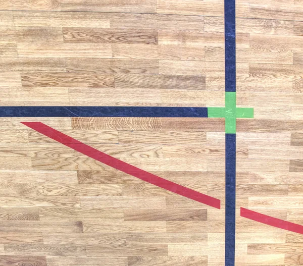 Green cross of lines. Shining floor of sports gymnasium
