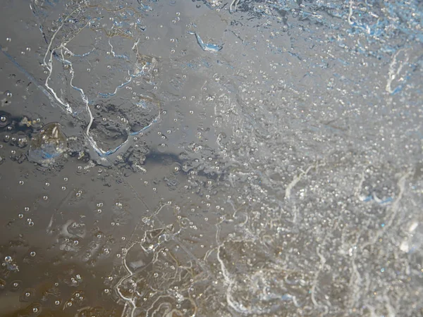 Cracks and bubbles in broken ice piece. Drifting ice floe