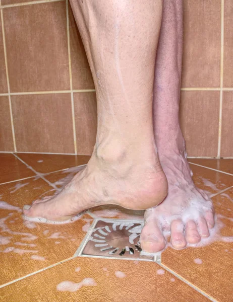 Adult  lovers playing with foot in shower. — Stock Photo, Image