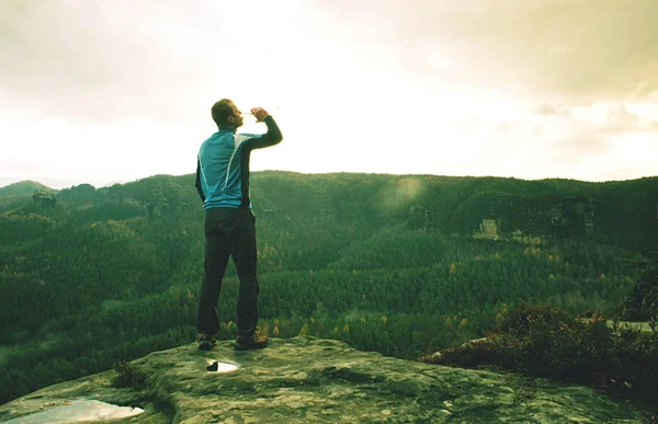 Man on a cliff edge on top of mountain with gorgeous view — Stock Photo, Image