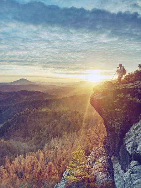 Nice woman in warm clothes photographing daybreak over  land — Stock Photo, Image