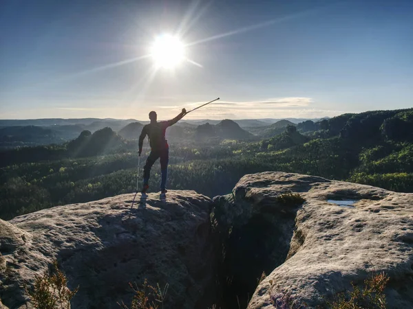 Man with crutches and strong will. Disabled tourist climb