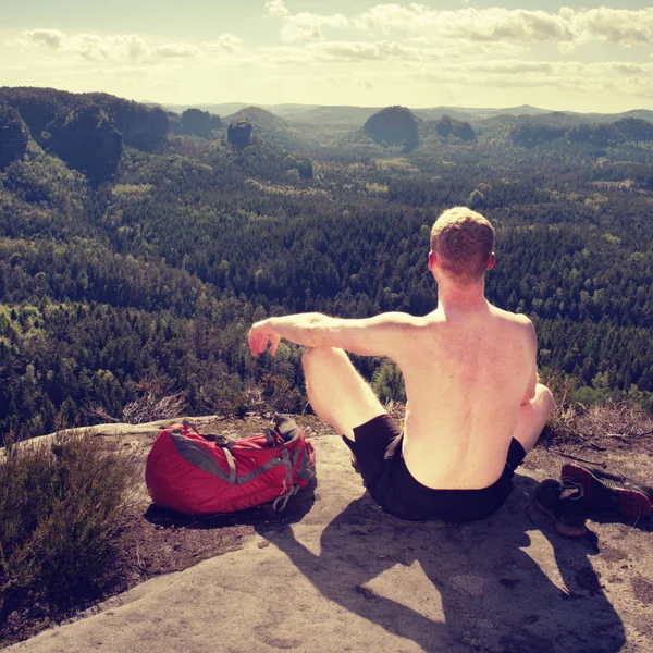 Shirtless man relaxing meditation with serene view mountains