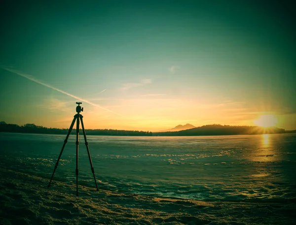摄影师三脚架准备拍摄冰冻的河流 — 图库照片