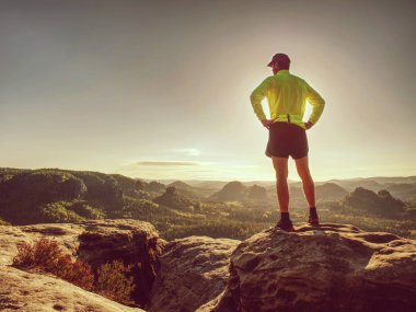 Dağ doğasının kayalık yolunda koşucu adam. Erkek sprinter 