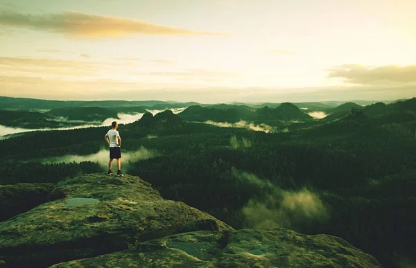 Man alone on summit. Man enjoy standing above noisy world